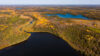 Aerial view of a peatland lake in Northern Ontario’s James Bay Lowlands, where golden-brown bog surrounds clear water—highlighting the fragile ecosystem of the Ring of Fire region.