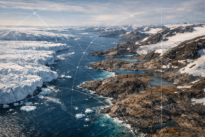 Aerial view of Greenland’s Arctic coastline showing melting ice cliffs beside exposed rocky land and open ocean, with faint geometric lines suggesting trade routes or resource mapping.